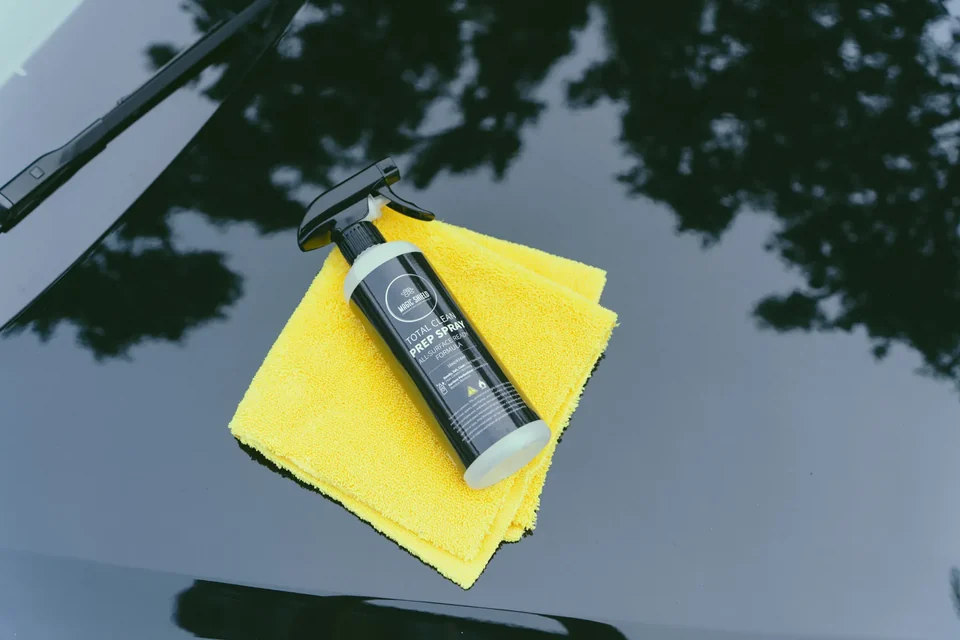 Magic Shield Prep Spray bottle and microfiber towel on clean automotive paint